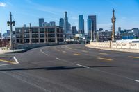 a street light on a bridge next to buildings and road sign in the city of san francisco