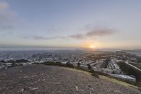 sunset and view to an city from the top of a hill in san francisco, california