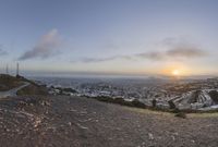 sunset and view to an city from the top of a hill in san francisco, california