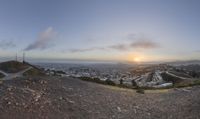 sunset and view to an city from the top of a hill in san francisco, california