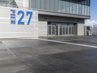 the sign reads norman cruise 377 is posted on an empty building's sidewalk