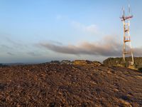 a large pile of dirt with a tower on top of it next to it's ground