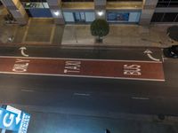 an overhead shot of street signs and a building at night time that are clearly visible