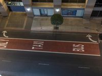 an overhead shot of street signs and a building at night time that are clearly visible