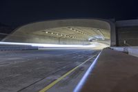 a car is driving through a tunnel with blurry cars traveling in the background and two lights that are going from inside