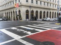 a white and red crosswalk on a street corner with a building in the background