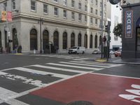 a white and red crosswalk on a street corner with a building in the background