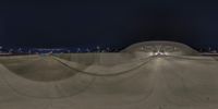 an image of someone skateboarding on the ramp at night time in a skate park