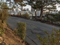 a view of the city from a hillside with a street sign in front of it