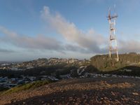 there is a large mound of dirt next to a radio tower with a antenna on the top of it