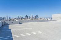 a view of a city skyline and parking lot at an airport roof top in san francisco, california