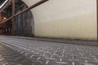 the stairs in a subway are painted yellow and grey, while another appears to have some gray dots on them
