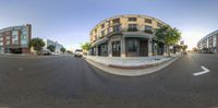 the view of a street through the fisheye lens lens, with buildings in the background