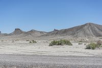 a red truck is driving through the rocky landscape of the desert of an arid area