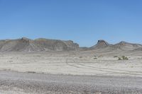 a red truck is driving through the rocky landscape of the desert of an arid area