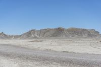 a red truck is driving through the rocky landscape of the desert of an arid area