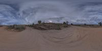 a photo of a very strange looking view of the sky and sand dunes on a cloudy day