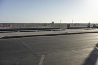 a man riding a skateboard up the side of a ramp in an empty parking lot