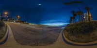 a panorama mirror image with a crescent and the beach at night in the background at seaport