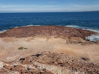 an empty area with rocks on the beach and ocean in the background for text reading area for kids