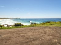 empty road in front of the beach on a sunny day with a clear sky above it