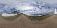 a fish eye view of a lighthouse and the ocean in the distance while on the left side