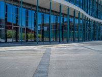 a concrete structure made into rows of orange and yellow poles are on a cement sidewalk