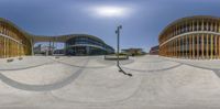 a fisheye image of some buildings in the sun on a skateboard park ride