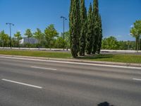 a concrete structure made into rows of orange and yellow poles are on a cement sidewalk