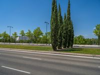 a concrete structure made into rows of orange and yellow poles are on a cement sidewalk