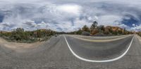 this is a reflection of an empty road taken from another side of the road in a 360 - panoramic photograph