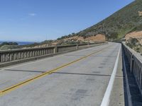 a paved highway with two lanes, one yellow on both sides and the other black on the other side