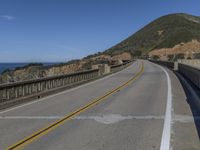 a paved highway with two lanes, one yellow on both sides and the other black on the other side