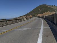 a paved highway with two lanes, one yellow on both sides and the other black on the other side