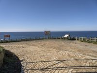 there is a bench on the top of the hill overlooking the ocean and water with no people