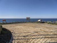 there is a bench on the top of the hill overlooking the ocean and water with no people