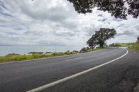 two lanes are lined up on a hill overlooking the water and a sky filled with clouds