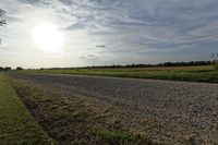 two large grain bins sit in the center of a field, surrounded by silos