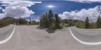 an 360 - turn photo shows a mountain and a wide road between two arrows the way forward