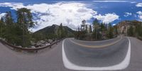 an 360 - turn photo shows a mountain and a wide road between two arrows the way forward