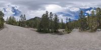 an 360 - turn photo shows a mountain and a wide road between two arrows the way forward