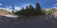 an 360 - turn photo shows a mountain and a wide road between two arrows the way forward