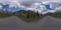 an 360 - turn photo shows a mountain and a wide road between two arrows the way forward