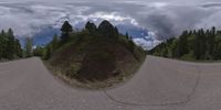 an 360 - turn photo shows a mountain and a wide road between two arrows the way forward