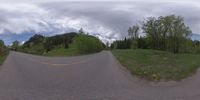 an 360 - turn photo shows a mountain and a wide road between two arrows the way forward