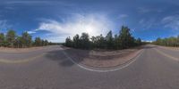 an 360 - turn photo shows a mountain and a wide road between two arrows the way forward