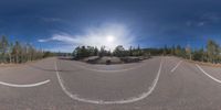 an 360 - turn photo shows a mountain and a wide road between two arrows the way forward