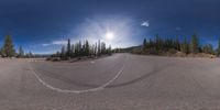 an 360 - turn photo shows a mountain and a wide road between two arrows the way forward