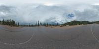 an 360 - turn photo shows a mountain and a wide road between two arrows the way forward