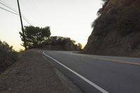 a street that has some rocks on it and the road is yellow and white, with a number of two points up to it